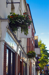 Fototapeta na wymiar english street with flower decorations. english buildings