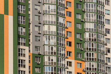 Fototapeta premium The facade of a multi-storey building with windows and balconies as an element of the architecture of a modern city