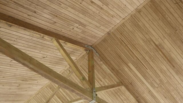 Interior view of a wooden roof structure. Travelling shot