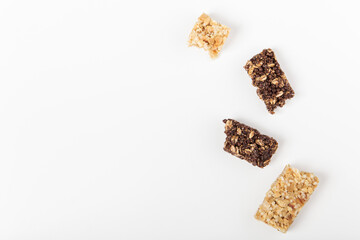 white and brown cereal bars. healthy sweet granola bar. white background. top view with copy space