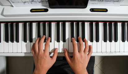 hands playing piano, Top view