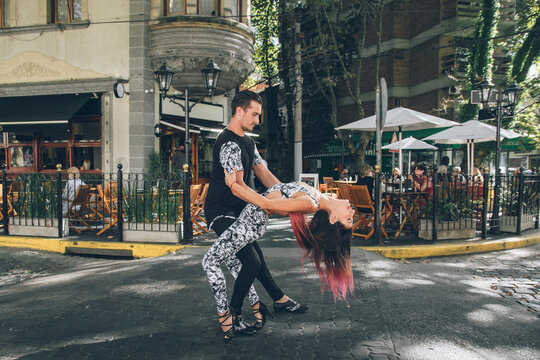 Young Hispanic Couple Dancing Bachata, Salsa On Street