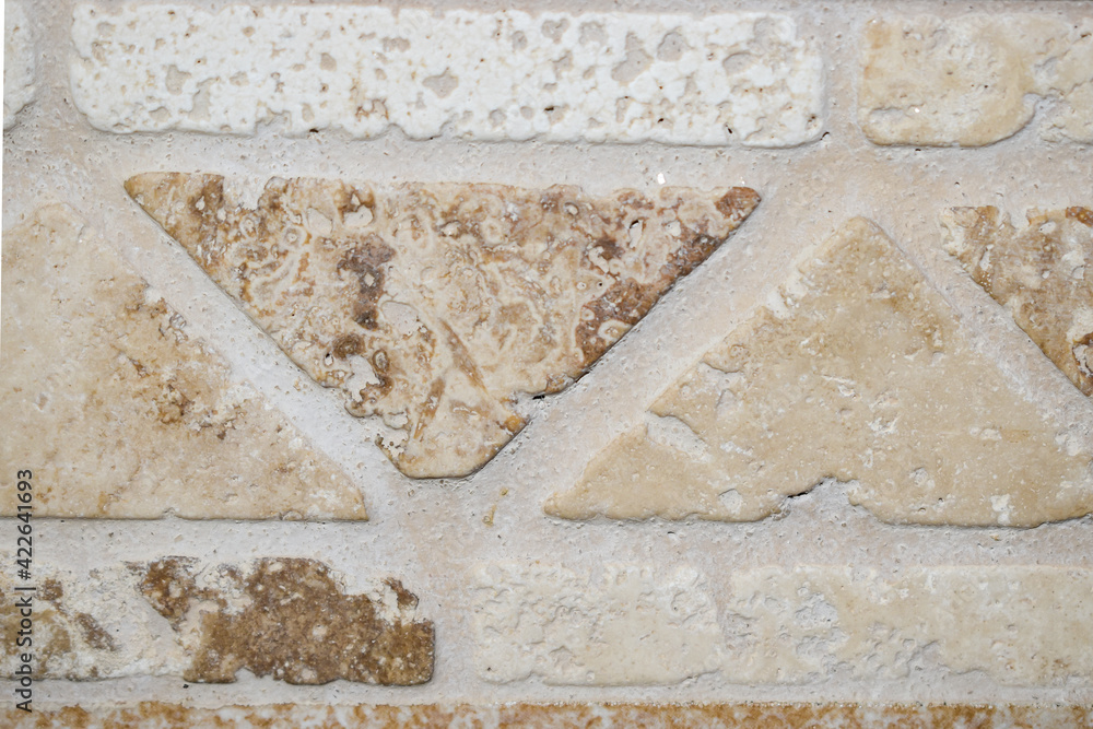 Poster wall texture with triangular and rectangular tiles