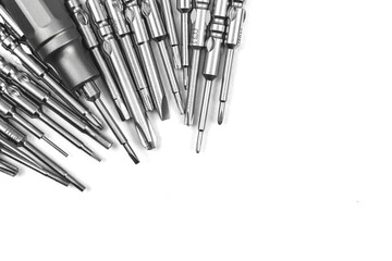 Screwdriver with replaceable set of metal bits on white isolated background, copy space