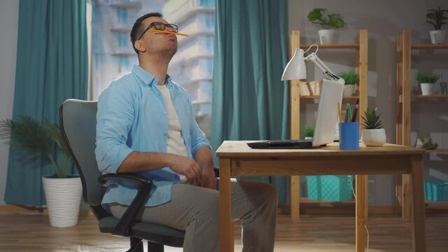 male office worker or freelancer sits during working hours and idles or procrastinates