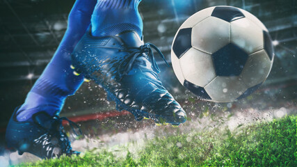 Football scene at night match with close up of a soccer shoe hitting the ball with power - obrazy, fototapety, plakaty