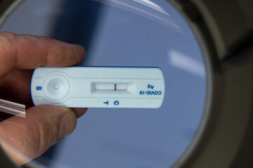 negative Covid test is held under a magnifying glass