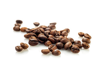 Coffee beans scattered randomly on a white background