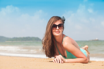 Young female enjoying sunny day on tropical beach
