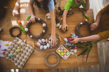 Making homemade Easter wreath of vines decorated with eggs