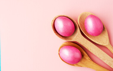 easter background with delicate color pink paint eggs on beige background 