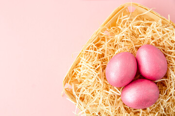 easter background with delicate color pink paint eggs on beige background 
