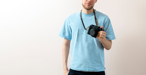 happy person holding a vintage old camera and making photos