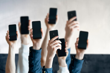 large group of people hold digital phones device, many human hands