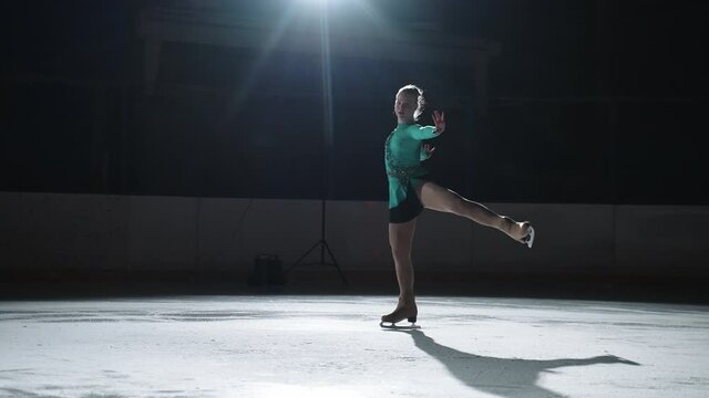 future champion of female figure skating is performing on ice rink, junior competition, demonstration performance