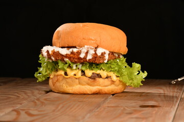A hamburger (also burger for short) is a sandwich consisting of one or more cooked patties of ground meat, usually beef, placed inside a sliced bread roll or bun.
