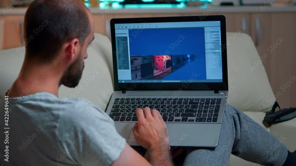 Poster caucasian game developer working on gameplay and game level late at night from the confort of his ho