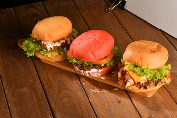 A hamburger (also burger for short) is a sandwich consisting of one or more cooked patties of ground meat, usually beef, placed inside a sliced bread roll or bun.
