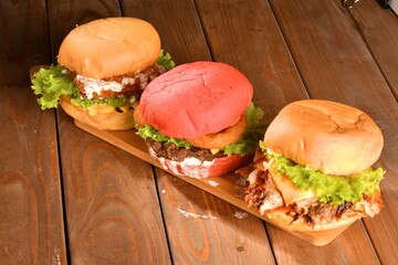A hamburger (also burger for short) is a sandwich consisting of one or more cooked patties of ground meat, usually beef, placed inside a sliced bread roll or bun.
