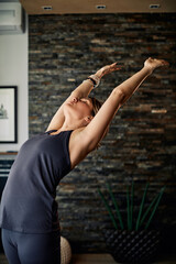 A woman practicing yoga at home. A woman in mountain yoga pose.