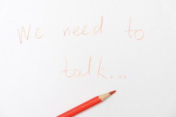 We need to talk message written on white paper, communication problems in family or work office space