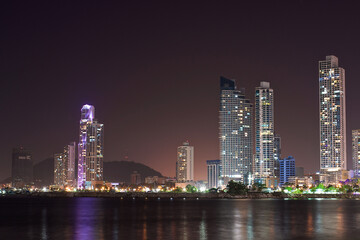 night Cityscape from across the bay in Panama with a serene reflection on the water. 