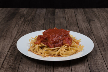 Pasta with rustic tomato sauce. Bavette pasta in red sauce. Gastronomic photography with top space for text. Gourmet photo of popular pasta.
