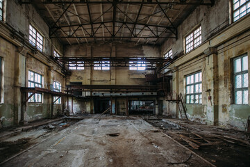 Fototapeta na wymiar Abandoned concrete factory. Large empty industrial hall