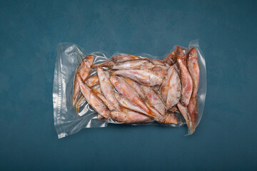 Frozen fish Mullus barbatus (red mullet) in pack. Top view, copy space