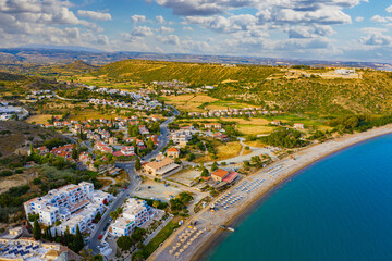 Fototapeta premium Panorama from Cyprus beach. Pissouri resort view from drone. Resort hotels with access to beach. Panorama of beach of city of Pissouri. Rest on island of Cyprus. Nature of Republic of Cyprus.