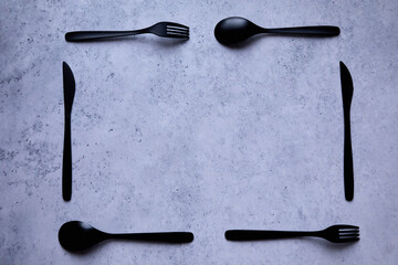 black cutlery on a marble table - 422653222