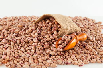 Pinto beans, a legume native to the American continent; photo on white background.
