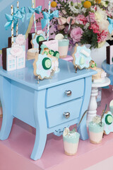 Candy table: cake, cookies, and desserts; themed decoration for feminine children's party.
