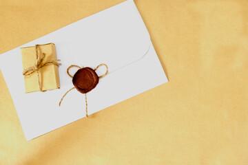 A letter with a wax seal and a small gift.