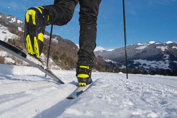 Male person cross-country skiing in beautiful winter landscape in mountains. Swiss Alps, Switzerland, Europe