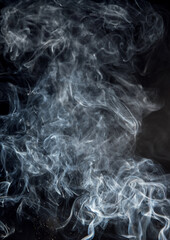 Abstract puffs of smoke on a black background.