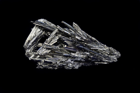 Stibnite specimen, from China. 174 grams. Slender prismatic crystals, reflective gray iridescent color. 4 inches in length. Black background. 
