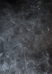 Abstract puffs of smoke on a black background.
