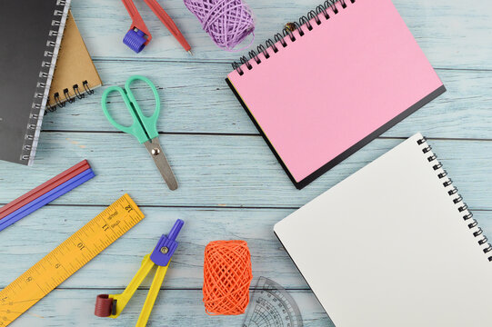 Stationery tools and notebook with copy space over wooden background