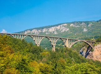 Fototapeta na wymiar Durdevica Tara arc bridge in the mountains of Montenegro. One of the highest automobile bridges in Europe.
