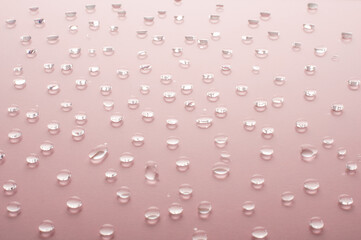 Water drops on pink background. beauty and spa concept.copy space. raindrops on glossy background
