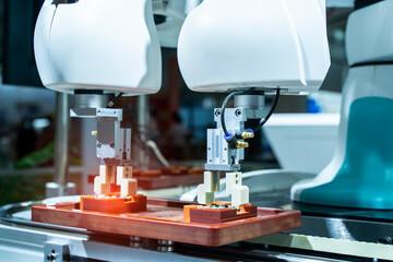 robotic arm catch for electronic assembly line. The robot for smart technology manufacturing process.