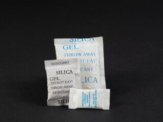 silica gel sachets on the corner of a black background