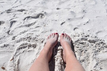 Woman’s feet on the beach