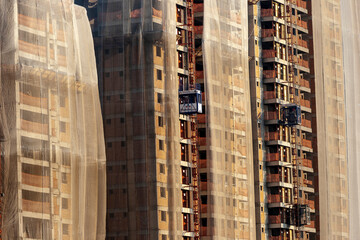 Sao Paulo, Brazil, July 27, 2011. Residential building construction site with net protection and outdoor elevator in Sao Paulo city