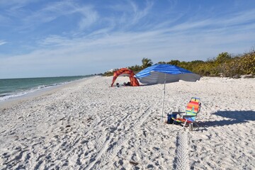 beach with umbrella and beach chair