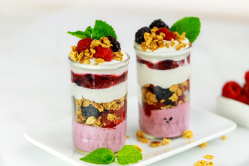 Berry dessert with mousse, granola and fresh berries.