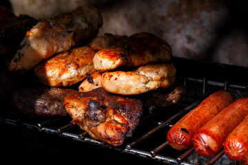 grilled chicken and grilled sausages on the grill