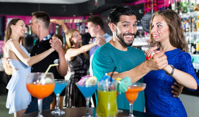 Female with man are dancing in pair on party in the bar
