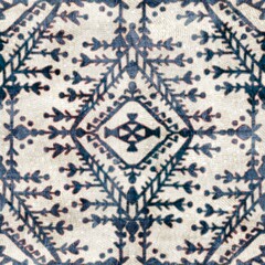 Seamless grungy tribal ethnic rug motif pattern. High quality illustration. Distressed old looking native style design in shades of gray and cream. Old artisan textile seamless pattern.